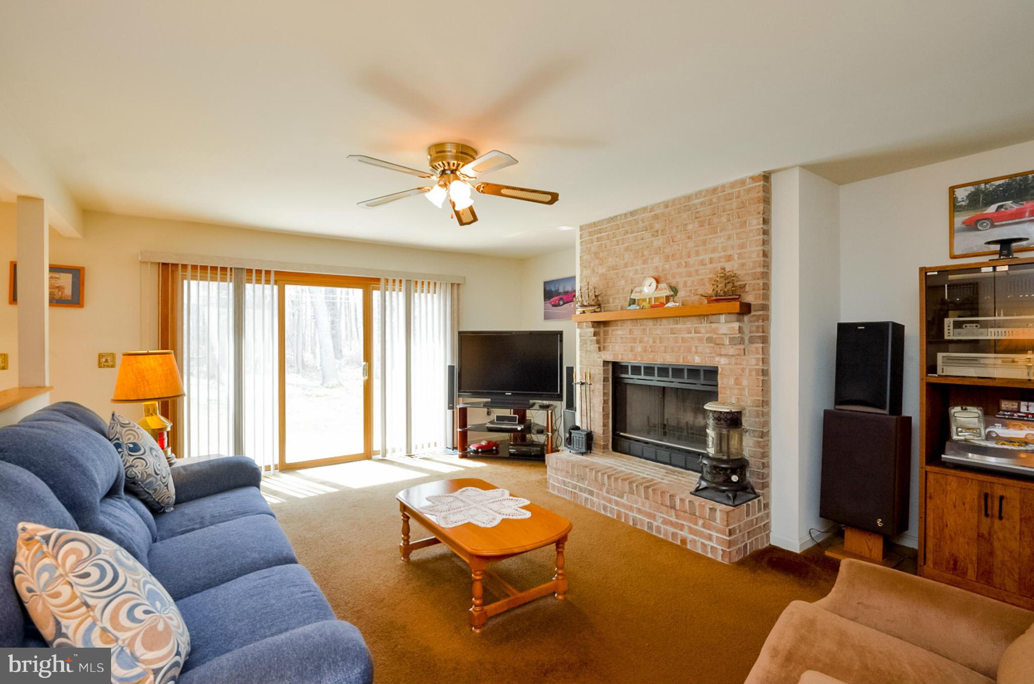 575 Pasture Brook Road Severn, MD 21144 - Photo 13 of 29 a living room with furniture a fireplace and a flat screen tv