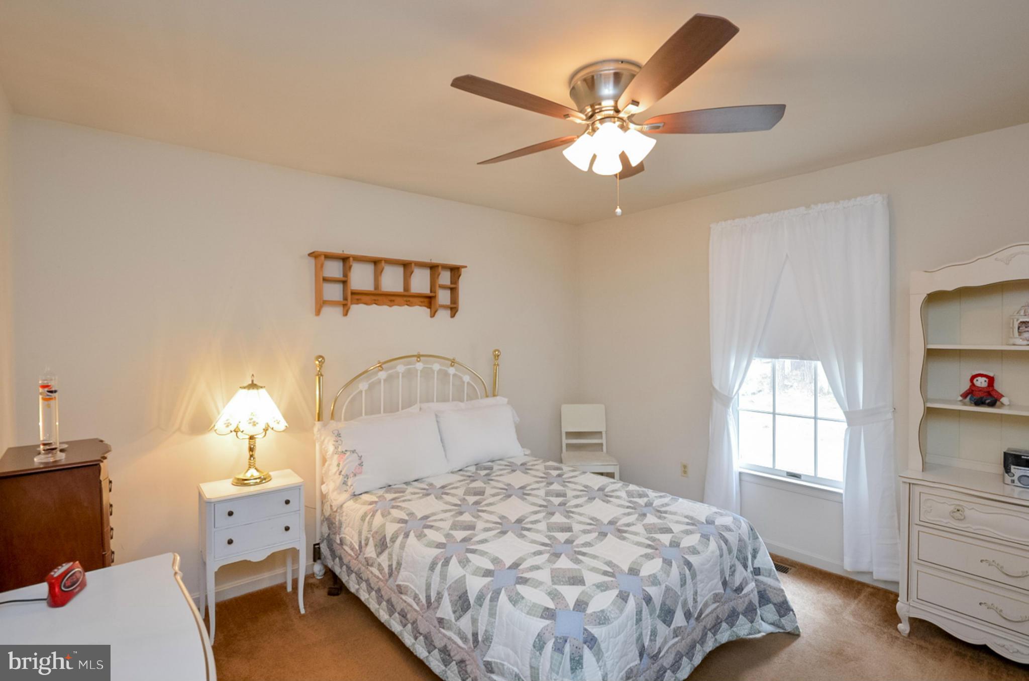 575 Pasture Brook Road Severn, MD 21144 - Photo 20 of 29 a bedroom with a bed and a chandelier