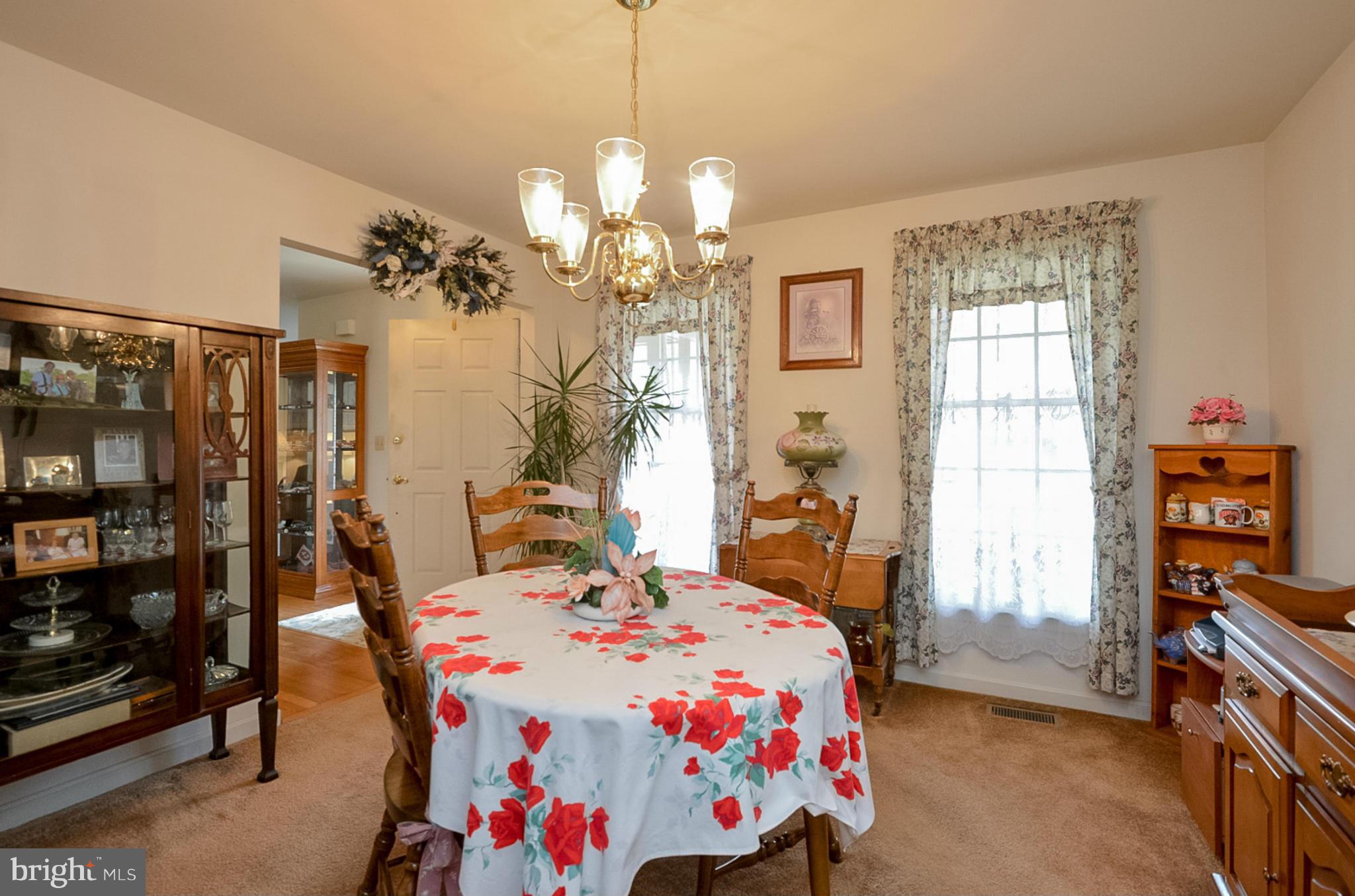 575 Pasture Brook Road Severn, MD 21144 - Photo 5 of 29 a bedroom that has a bed and a chandelier
