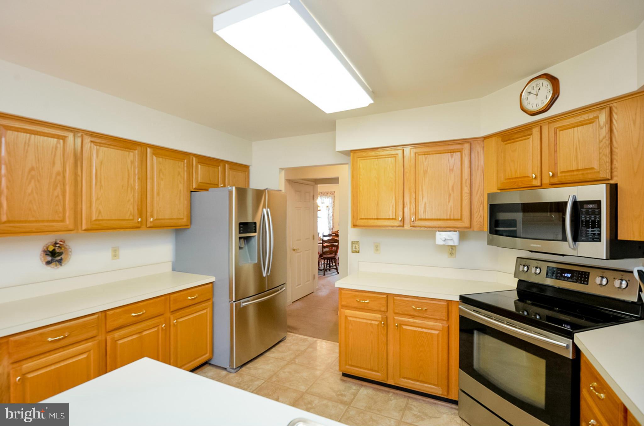 575 Pasture Brook Road Severn, MD 21144 - Photo 6 of 29 a kitchen with stainless steel appliances a stove sink microwave and cabinets