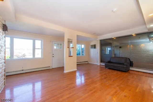 wooden floor in an empty room with a window