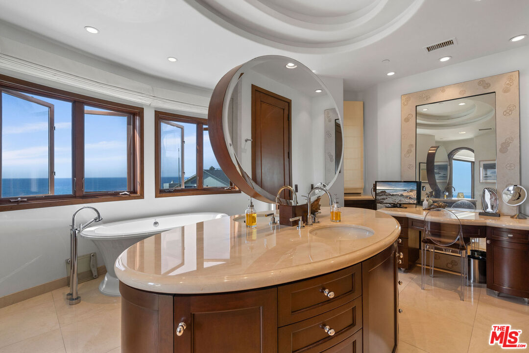 31554 Victoria Point Road Malibu, CA 90265 - Photo 33 of 45 a bathroom with a granite countertop sink and a mirror