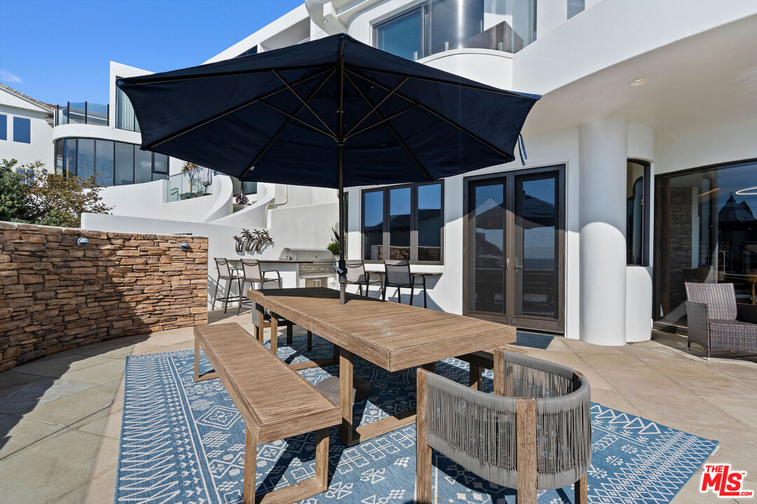31554 Victoria Point Road Malibu, CA 90265 - Photo 40 of 45 a patio with table and chairs
