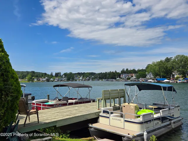 a view of a balcony with two chairs and a potted plant