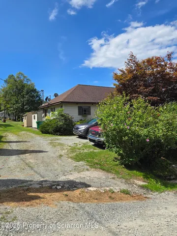 a view of a street with a lots of plants and trees