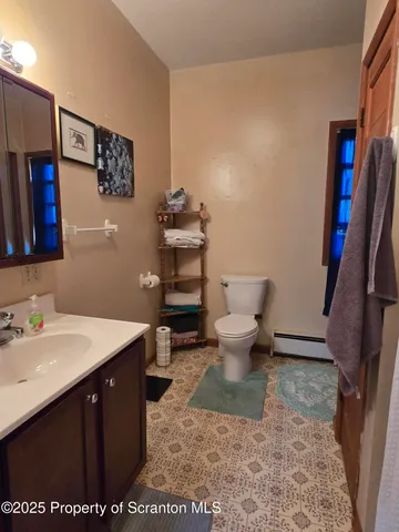 a bathroom with a sink a toilet and a mirror