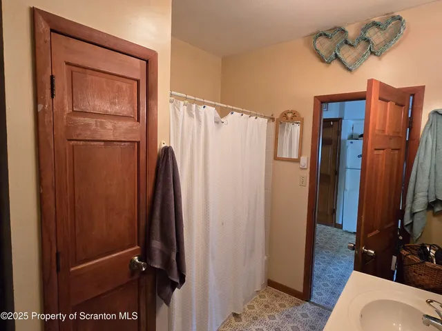 a bathroom with a shower toilet and sink
