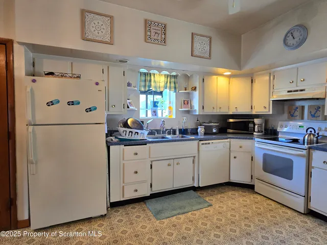 a kitchen with stainless steel appliances granite countertop a refrigerator sink and cabinets