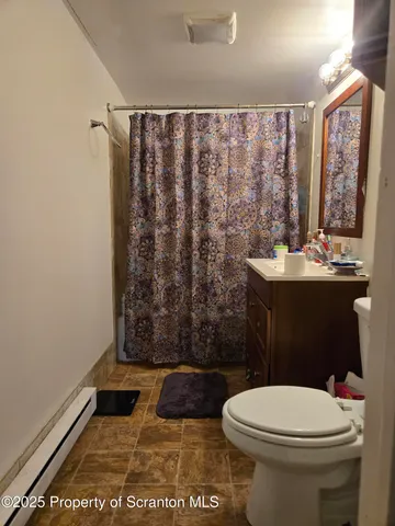 a bathroom with a toilet a sink and a shower