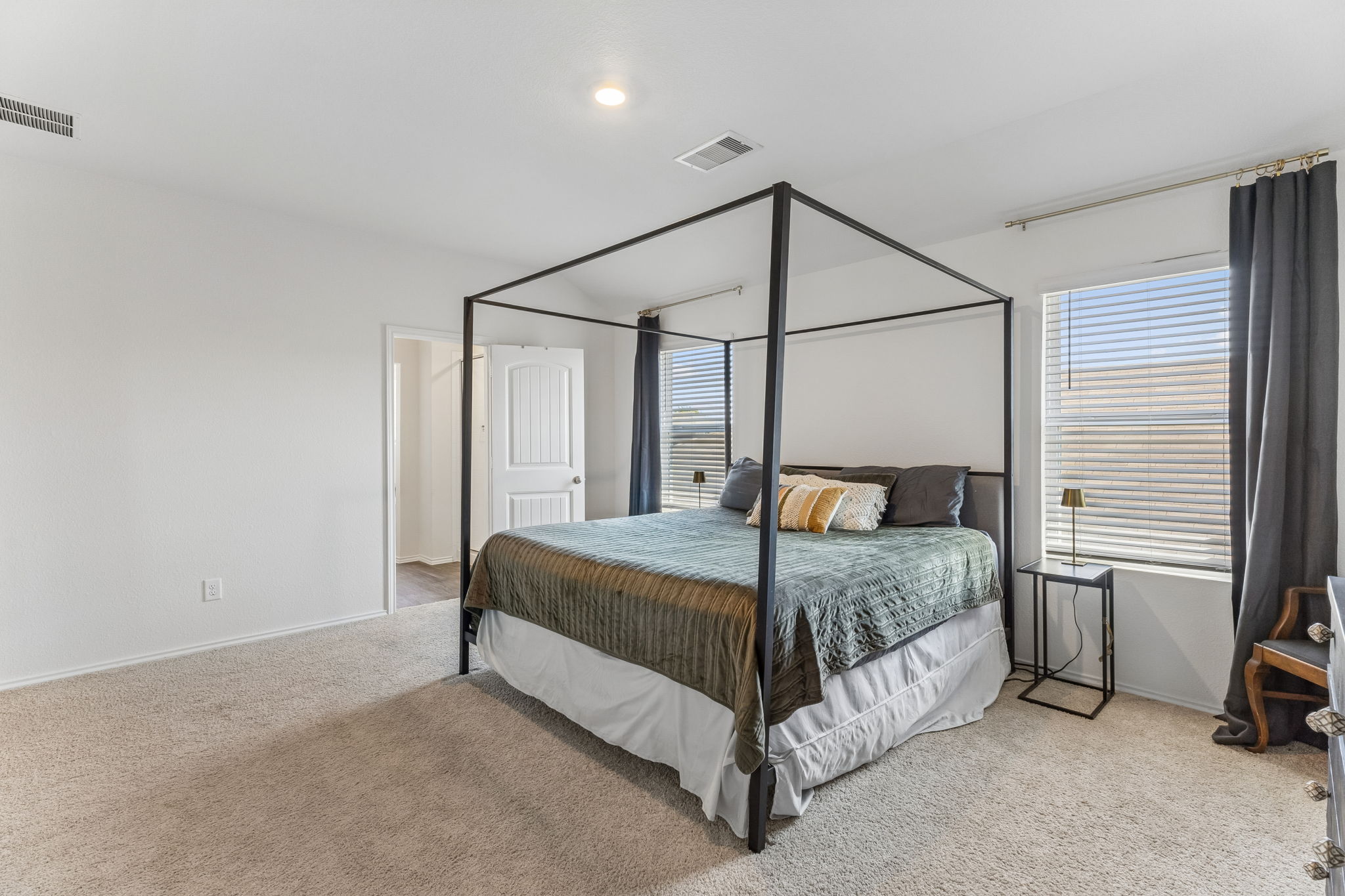 343 Sickle Loop Kyle, TX 78640 - Photo 25 of 40 Carpeted bedroom with a single window featuring horizontal blinds and dark gray drapes