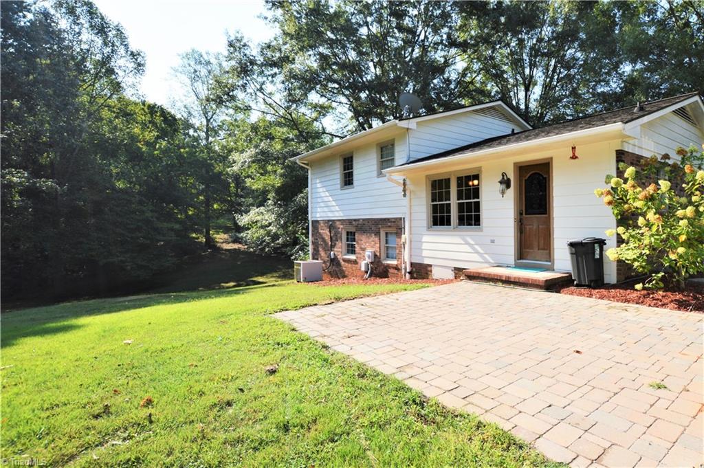 265 Pilotview Loop Madison, NC 27025 - Photo 26 of 30 Exterior back of house with brick pavers patio