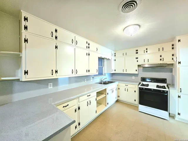 a kitchen with stainless steel appliances granite countertop a stove and a refrigerator