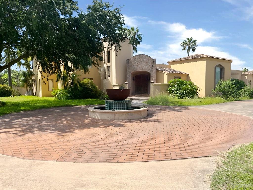 a front view of a house with a yard and a garage
