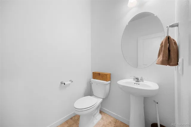a bathroom with a sink toilet and mirror