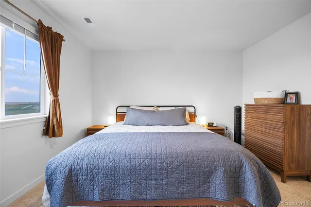 a bedroom with a bed and a dresser