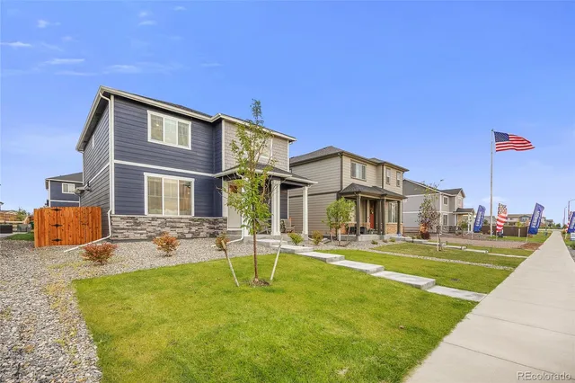 a front view of a building with a garden