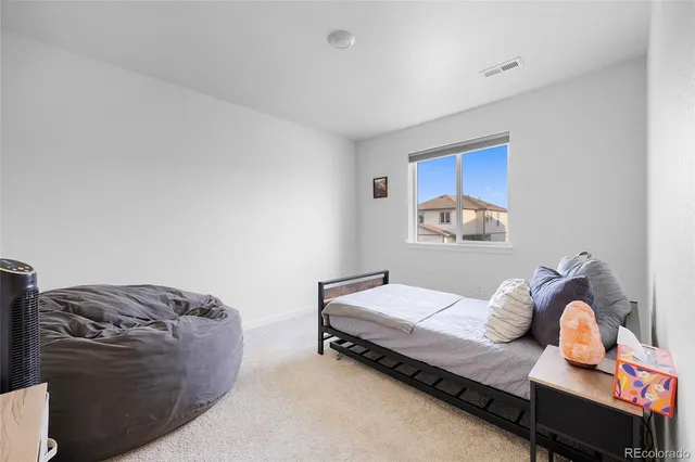 a bedroom with a bed and dresser
