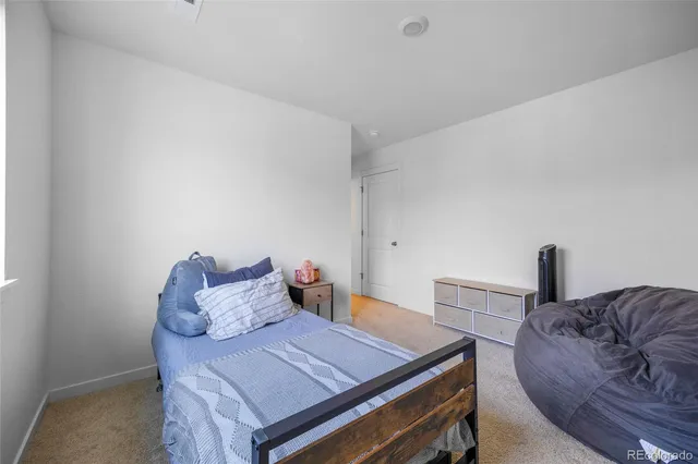 a bed room with a bed and a chair