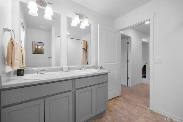 a bathroom with a double vanity sink and mirror
