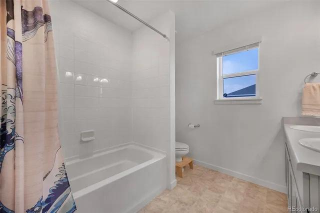 a bathroom with a bathtub a toilet and a shower