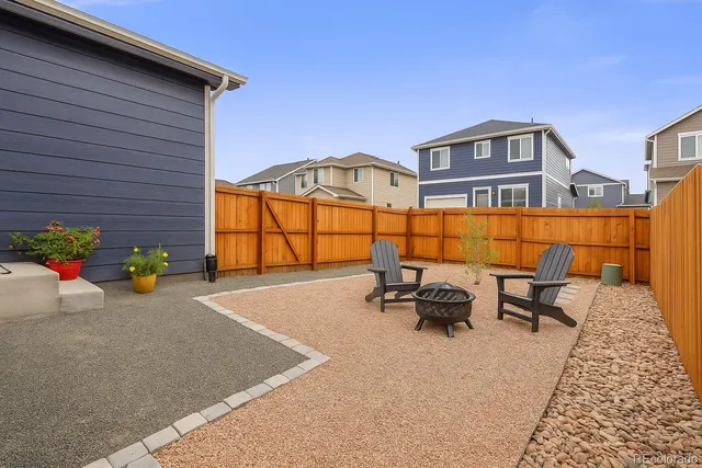 a backyard of a house with sofas
