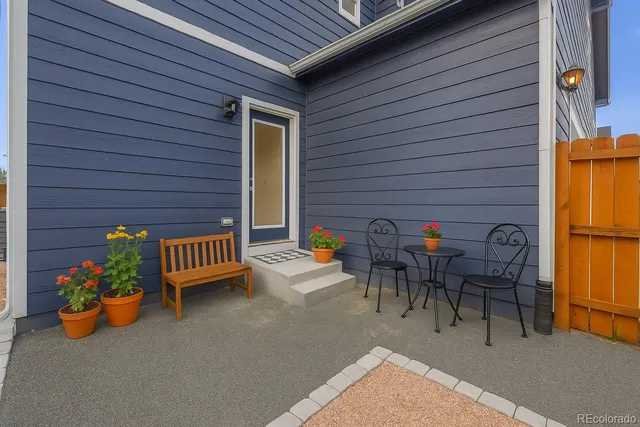 a view of a patio with table and chairs and potted plants