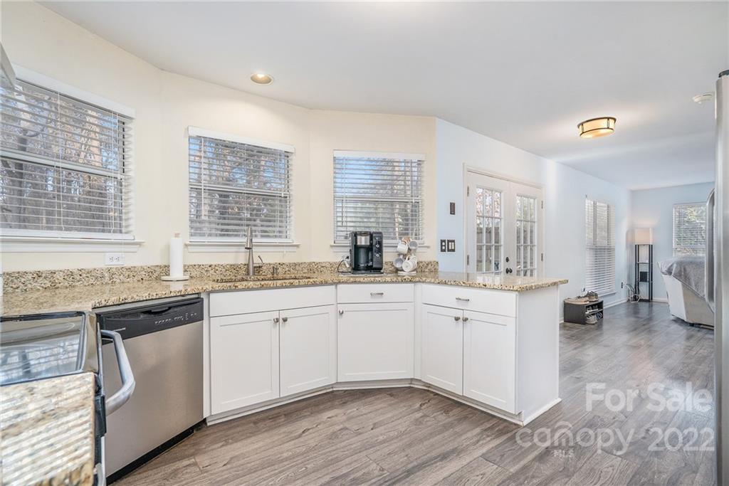 3011 Williams Station Road Matthews, NC 28105 - Photo 12 of 26 a kitchen with granite countertop white cabinets and white appliances