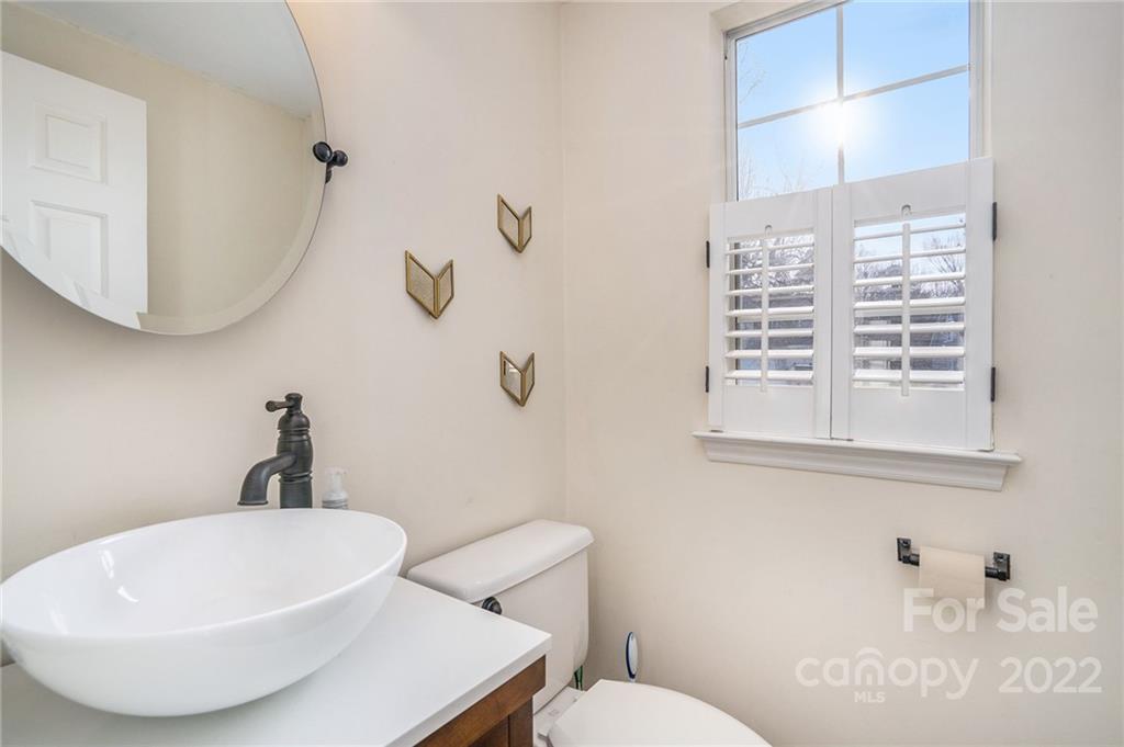 3011 Williams Station Road Matthews, NC 28105 - Photo 13 of 26 a bathroom with a sink a toilet and mirror