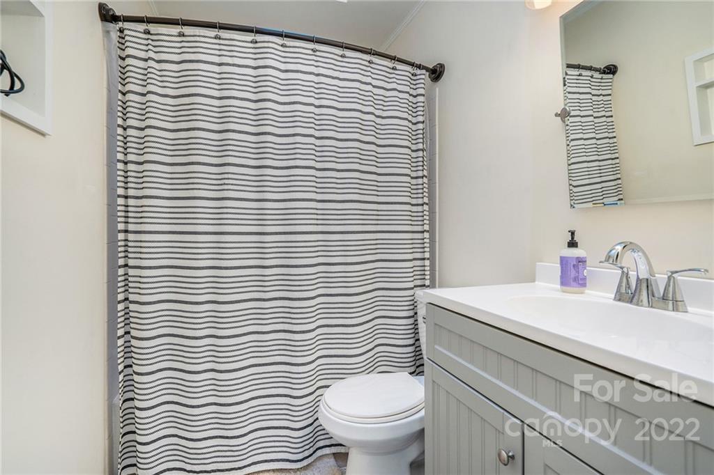 3011 Williams Station Road Matthews, NC 28105 - Photo 18 of 26 a bathroom with a sink a toilet and mirror
