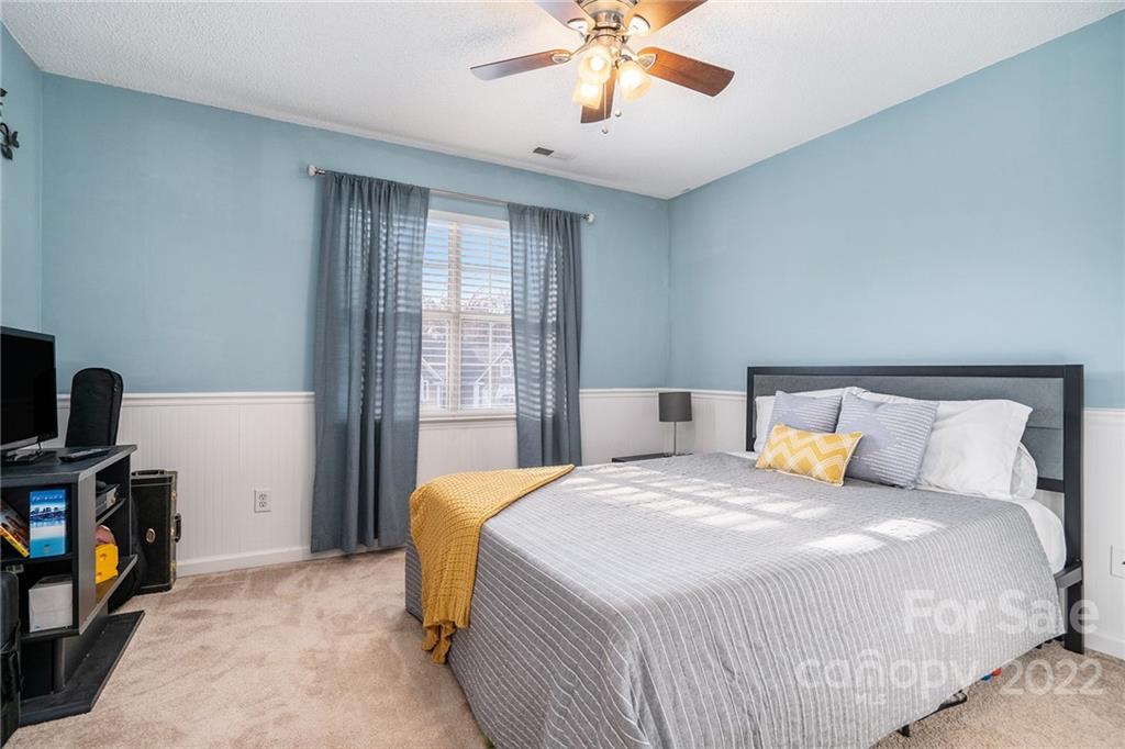 3011 Williams Station Road Matthews, NC 28105 - Photo 19 of 26 a bedroom with a bed and a chandelier