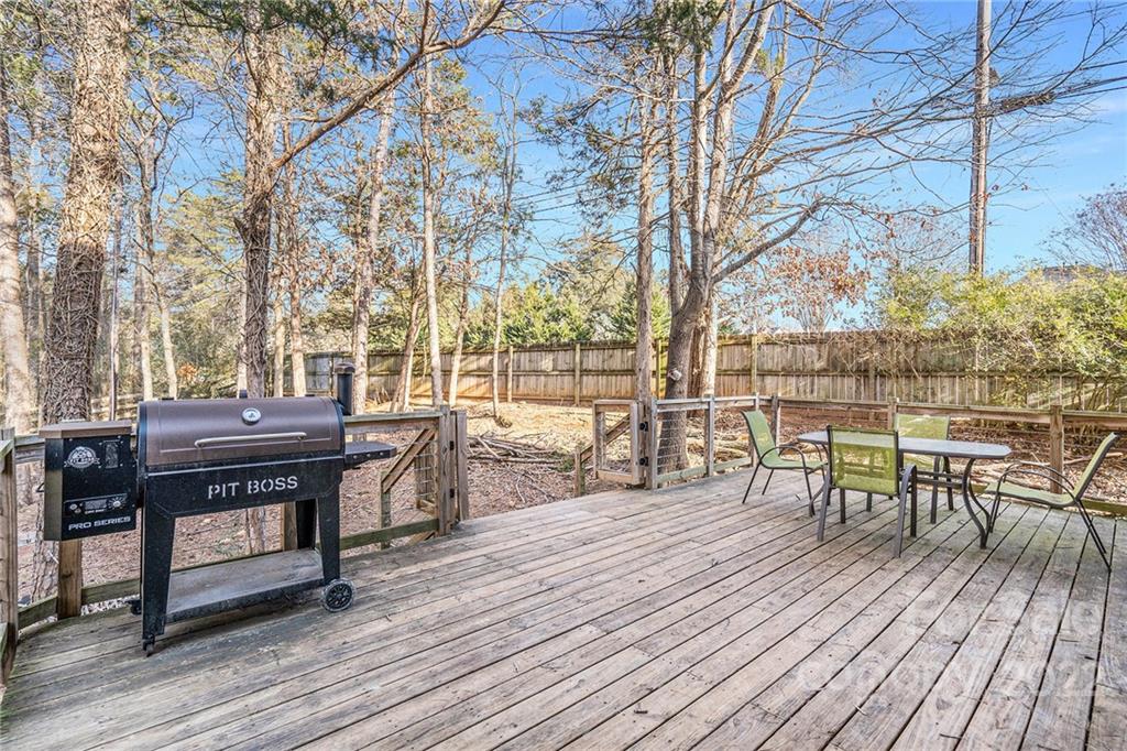 3011 Williams Station Road Matthews, NC 28105 - Photo 20 of 26 a view of a roof deck with table and chairs a barbeque with wooden floor and fence