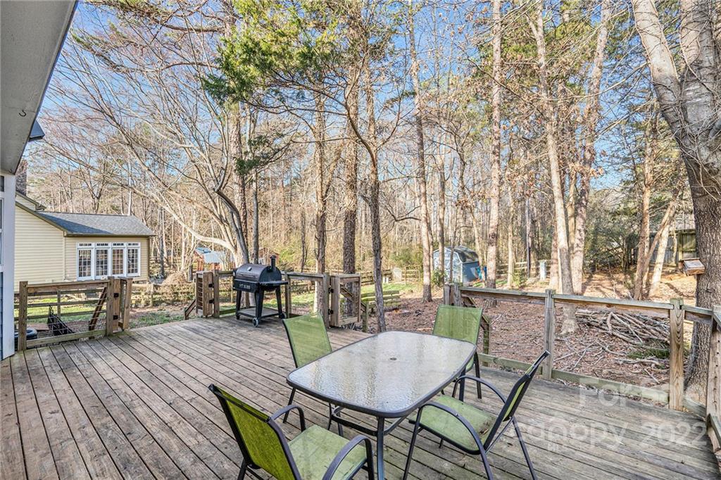 3011 Williams Station Road Matthews, NC 28105 - Photo 21 of 26 a view of a patio with table and chairs with wooden floor and fence