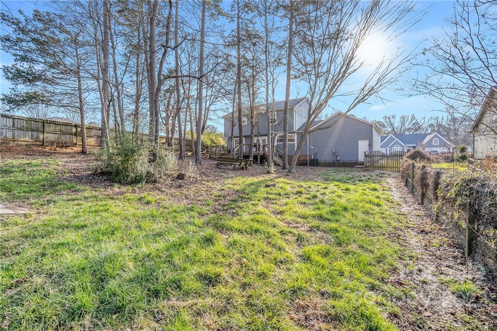 3011 Williams Station Road Matthews, NC 28105 - Photo 23 of 26 a backyard of a house with lots of green space and fountain