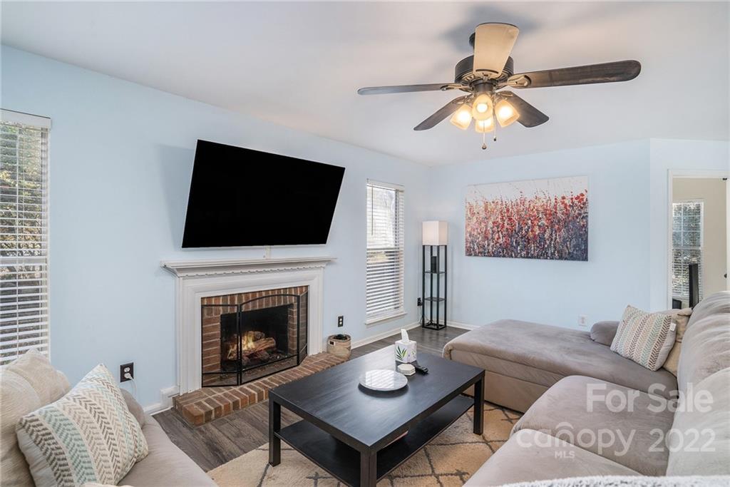 3011 Williams Station Road Matthews, NC 28105 - Photo 8 of 26 a living room with furniture a flat screen tv and a fireplace