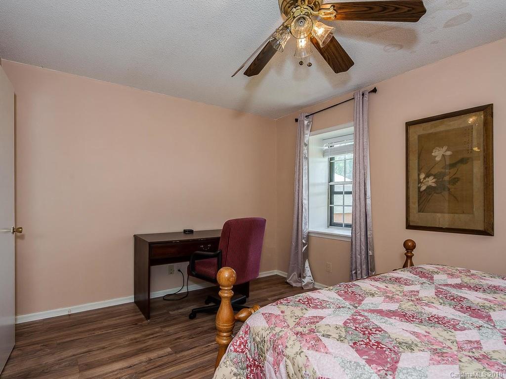 5825 Hunting Ridge Lane, Unit B Charlotte, NC 28212 - Photo 13 of 17 a bedroom with a bed and a chair