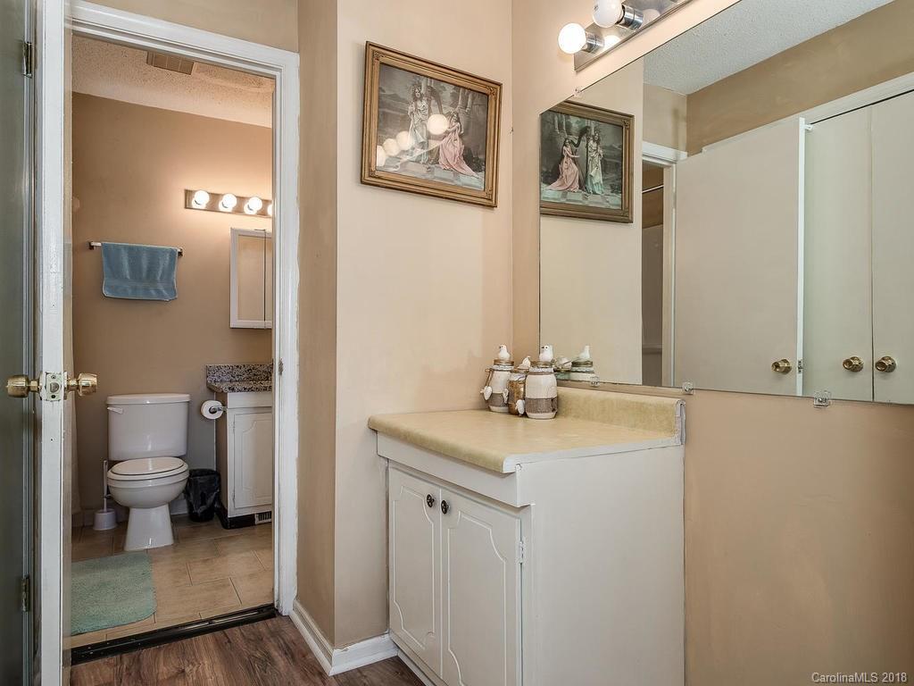 5825 Hunting Ridge Lane, Unit B Charlotte, NC 28212 - Photo 15 of 17 a bathroom with 2 sink toilet and a mirror
