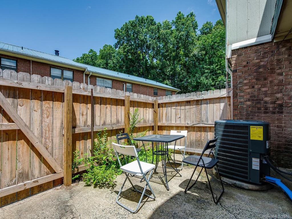 5825 Hunting Ridge Lane, Unit B Charlotte, NC 28212 - Photo 17 of 17 a view of a patio with table and chairs with wooden floor and fence