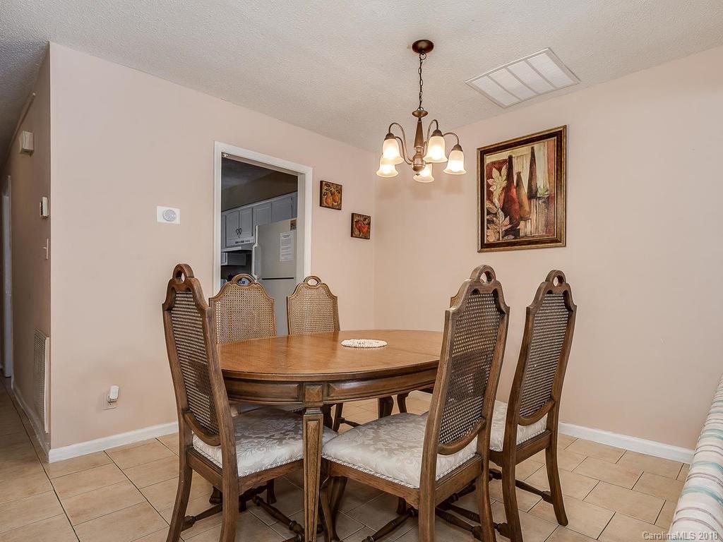 5825 Hunting Ridge Lane, Unit B Charlotte, NC 28212 - Photo 6 of 17 a view of a dining room with furniture and chandelier