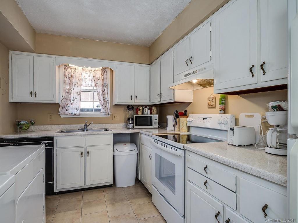 5825 Hunting Ridge Lane, Unit B Charlotte, NC 28212 - Photo 8 of 17 a kitchen with cabinets appliances a sink and a window