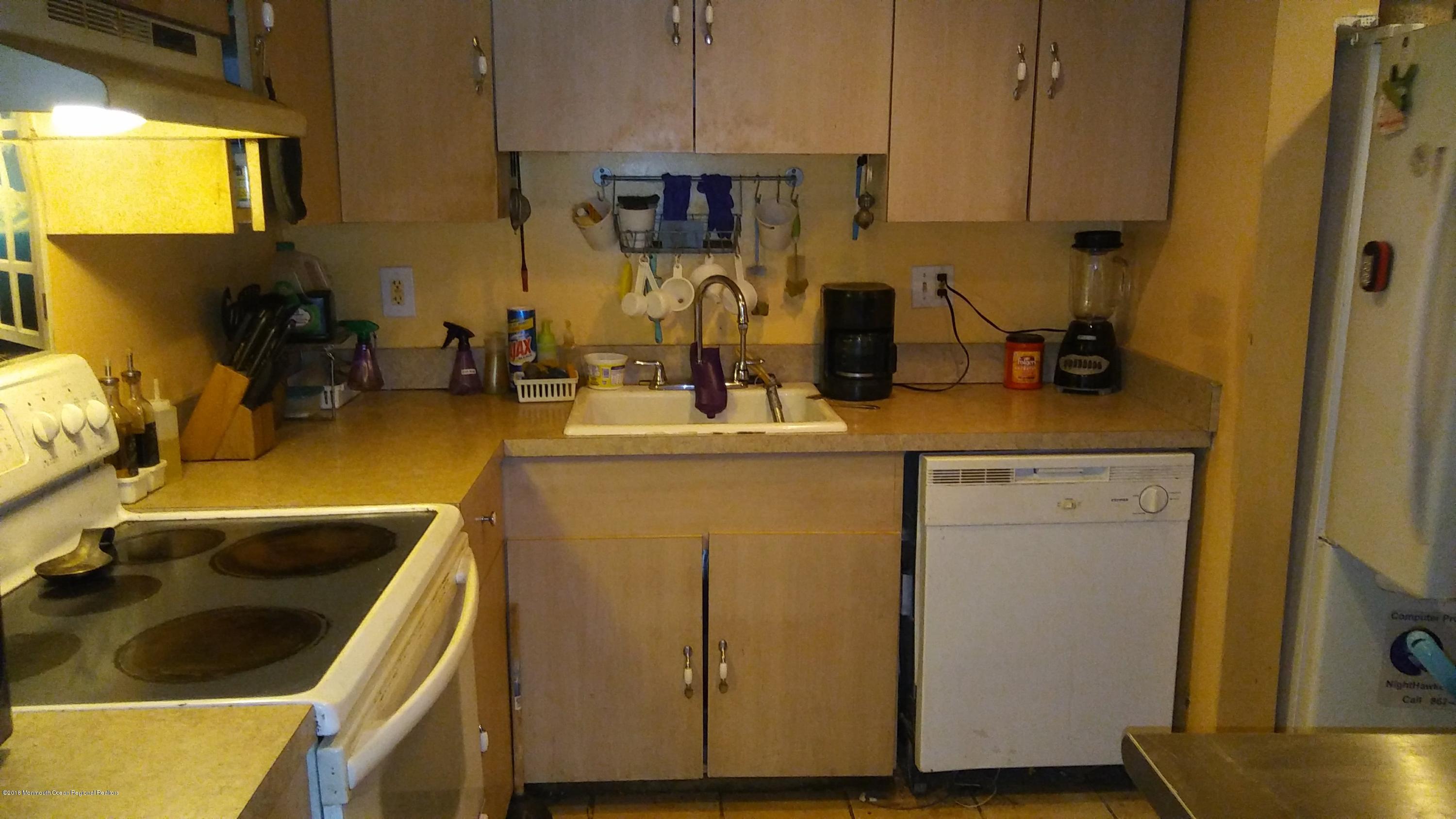 1102 Timber Creek Road Lindenwold, NJ 08021 - Photo 4 of 8 a kitchen with a sink and a refrigerator