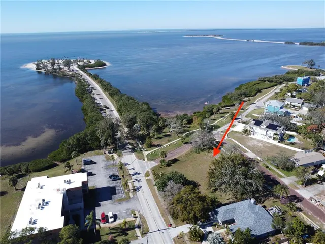 an aerial view of a house with a yard and lake view