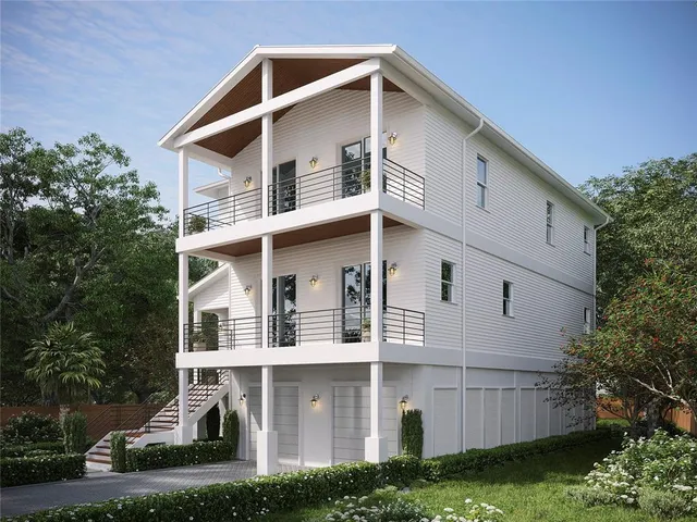 a view of a white house with a yard