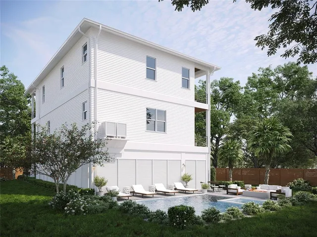 a kitchen with stainless steel appliances granite countertop a table chairs stove and white cabinets