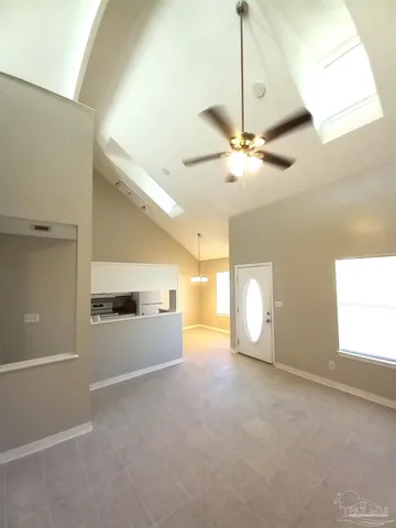 a view of a livingroom with a ceiling fan and window