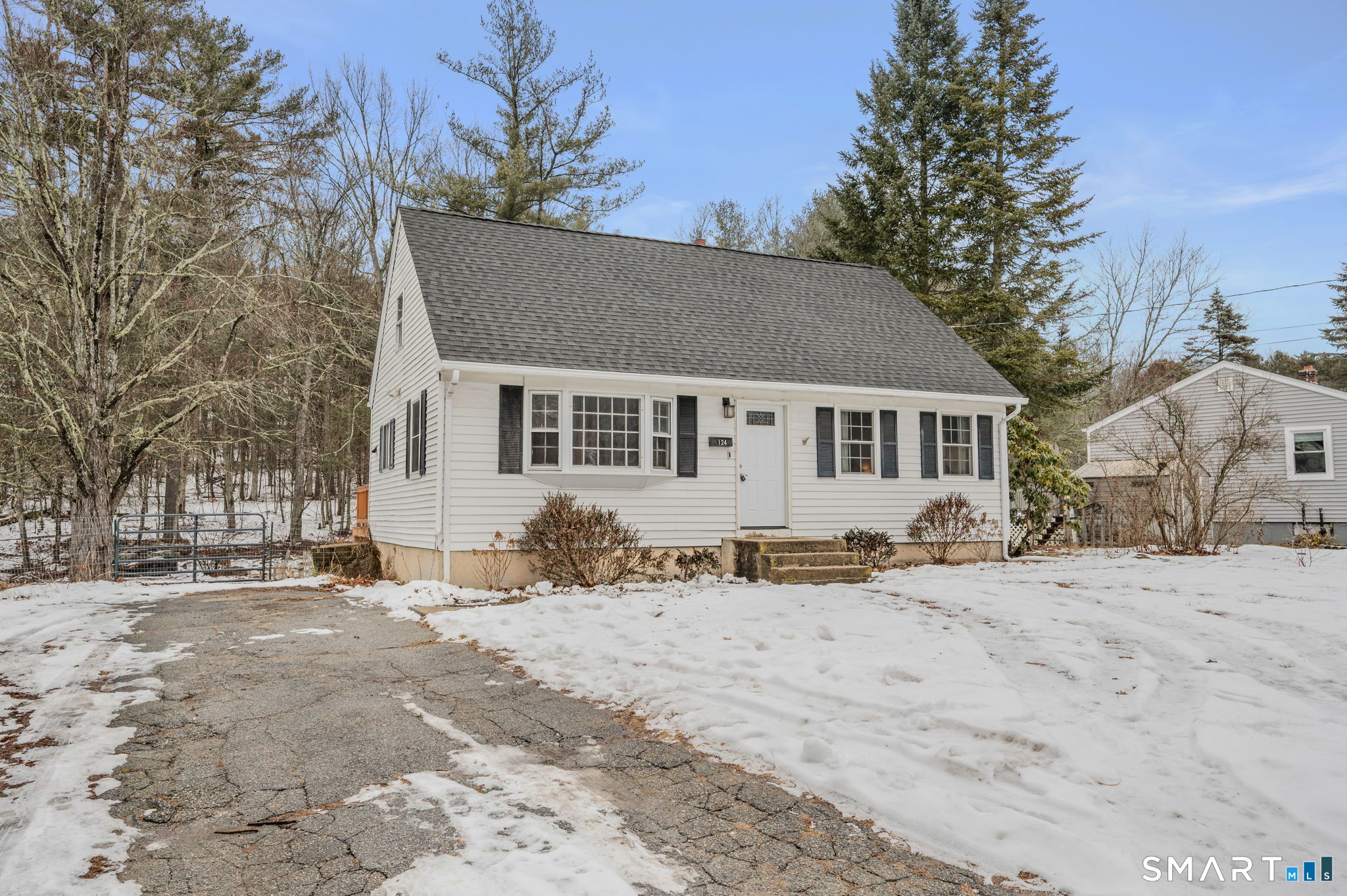 a front view of a house with a yard covered in snow