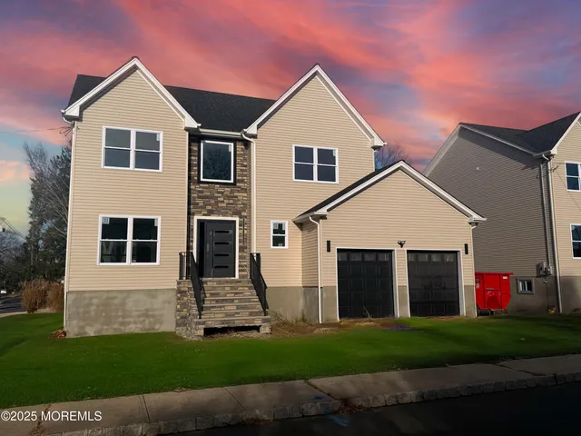a front view of a house with a yard and garage