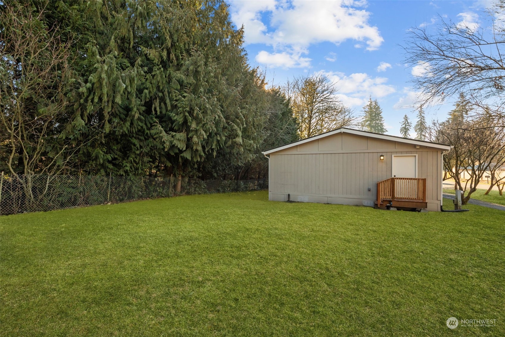 12017 Chappel Road Arlington, WA 98223 - Photo 25 of 40 a view of a backyard with potted plants and large trees