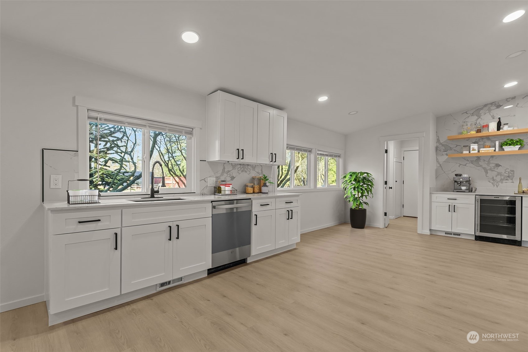 12017 Chappel Road Arlington, WA 98223 - Photo 8 of 40 a large white kitchen with stainless steel appliances granite countertop a stove a sink dishwasher and white cabinets with wooden floor