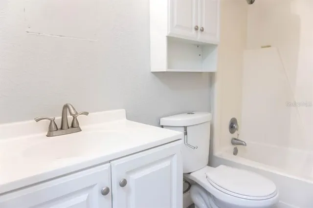 a bathroom with a sink a toilet and vanity
