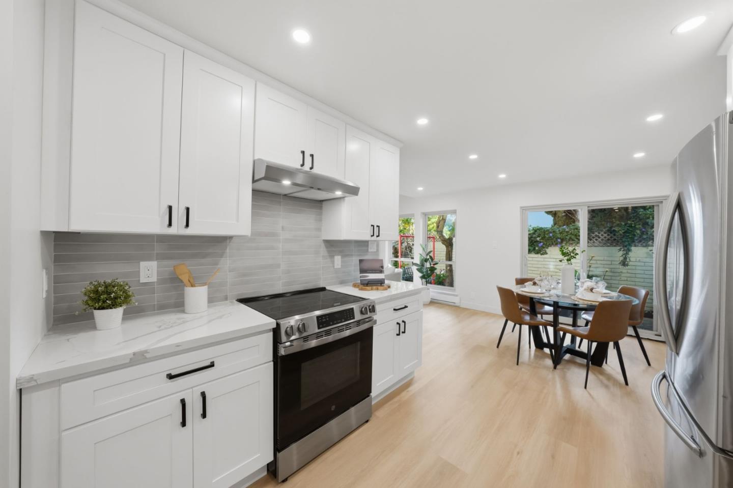 409 Puerto Place Hayward, CA 94541 - Photo 18 of 54 a kitchen with granite countertop stainless steel appliances a table and chairs